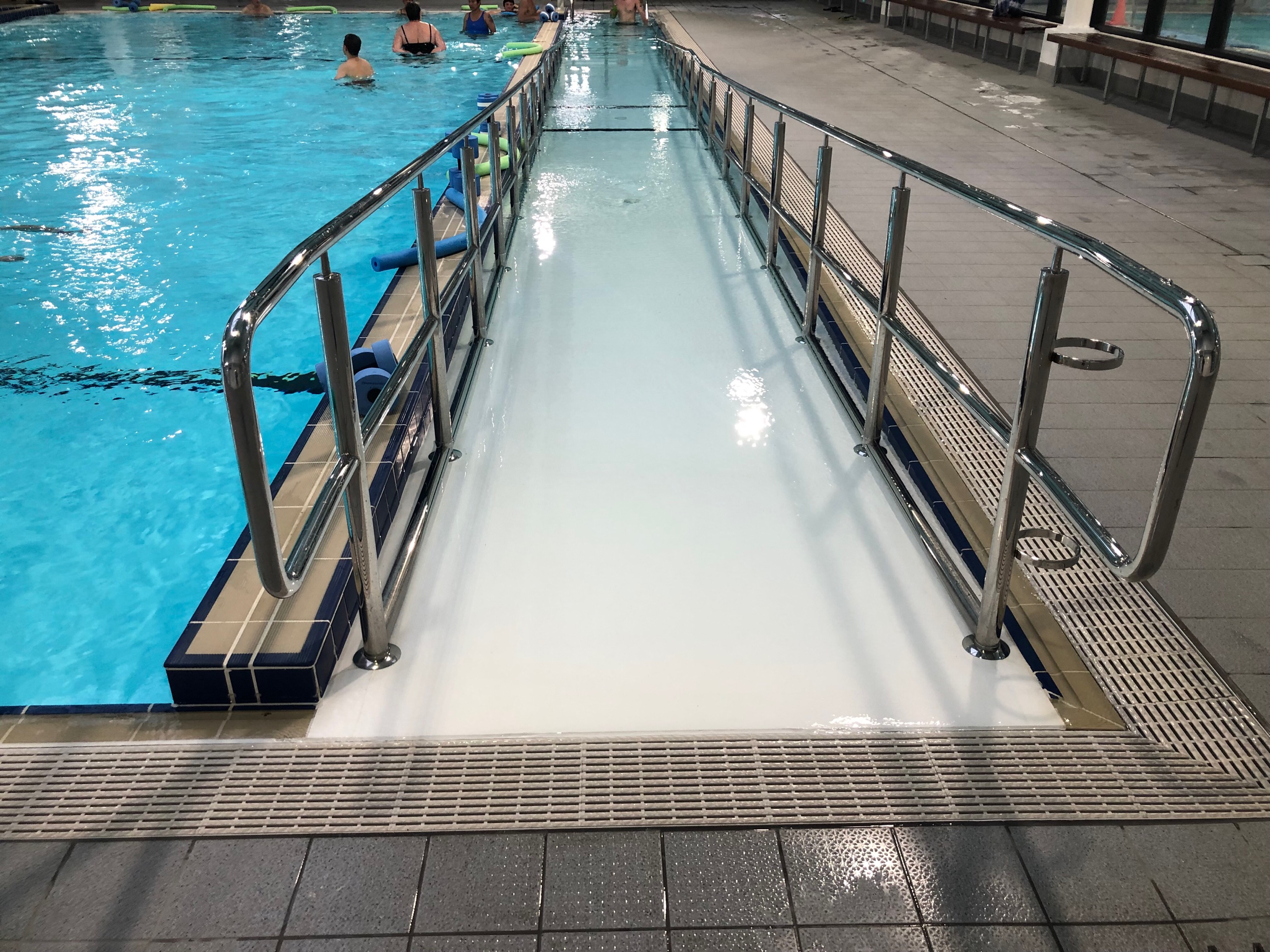 Image of ramp entrance to Warm Water Pool, featuring handrails