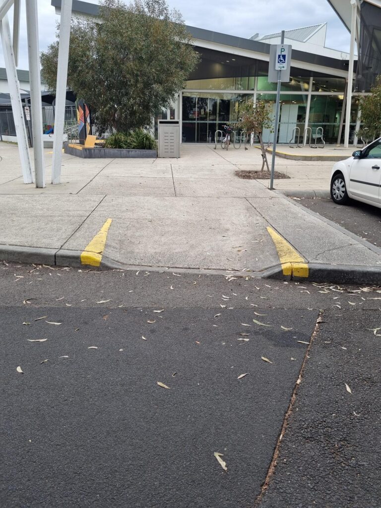 There is a ramp located next to the accessible parking bays that leads directly to the entry of AVLC. A taxi crop-off and pick-up area is located directly outside the entry to AVLC.