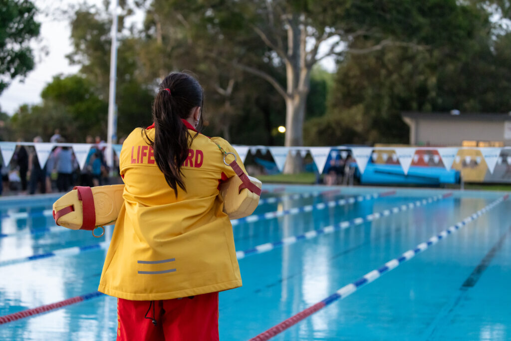 Lifeguard supervising outdoor pool
