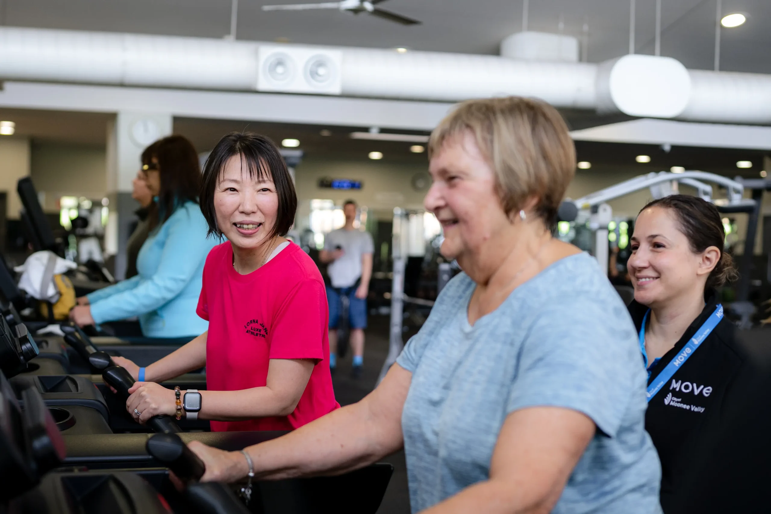 Patrons on treadmills with trainer